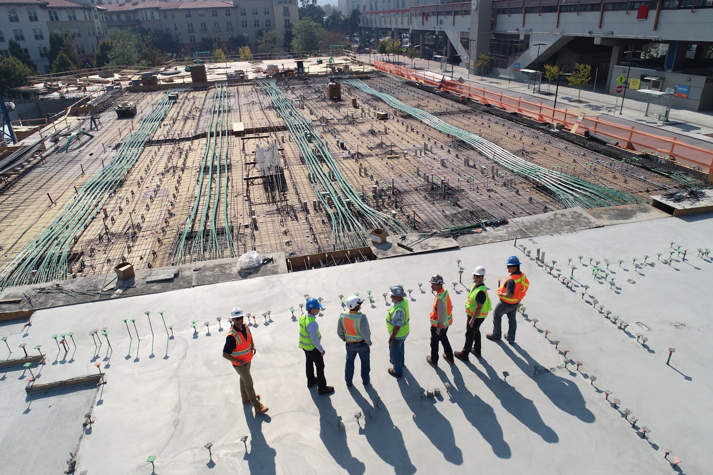 Construction crew reviewing a poured slab on a commercial site